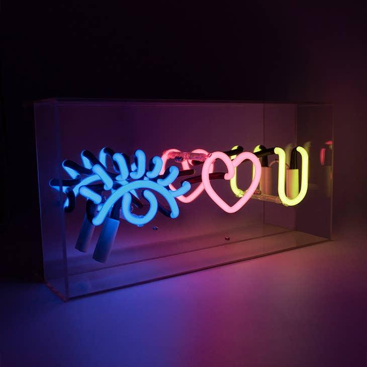 FORMA's Neon "Eye Love You" Lights in blue, red, and yellow, illuminating an affectionate message in a stylish way.