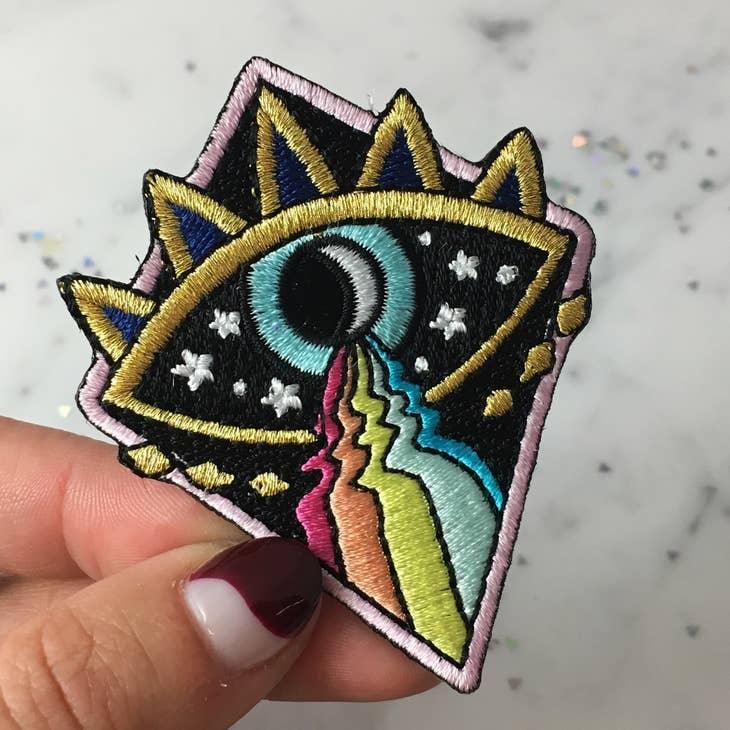 Cosmic Evil Eye Rainbow Patch, featuring a captivating blend of the evil eye symbol, cosmic design, and colorful rainbow.