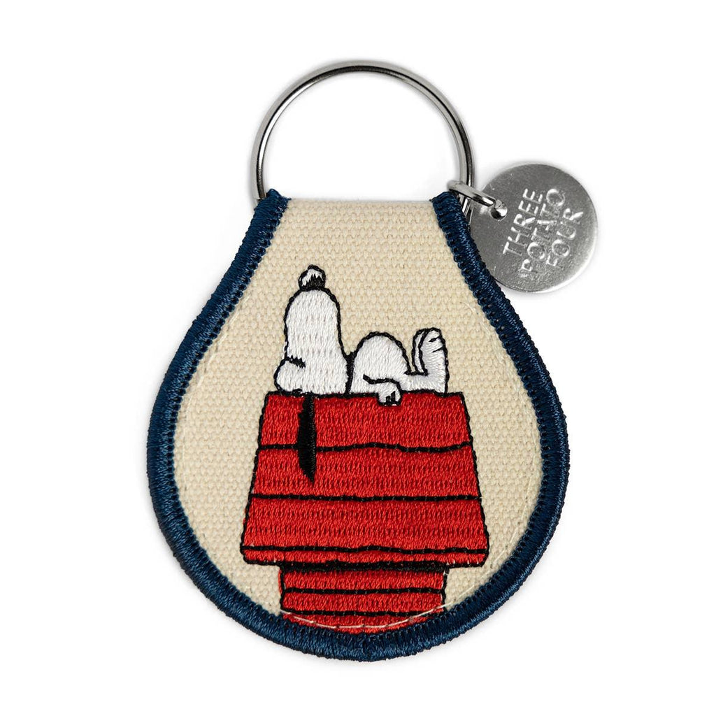 Peanuts Snoopy Doghouse Patch Keychain - A cute and nostalgic accessory featuring Snoopy's iconic doghouse. Perfect for keys or bags.