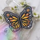 Vibrantly colored embroidered butterfly patch with detailed wing patterns.