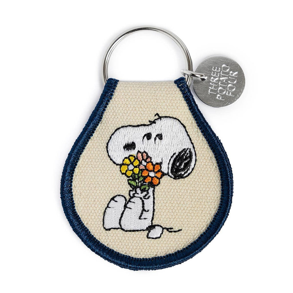 Peanuts Snoopy Flower Bouquet Patch Keychain - A whimsical accessory featuring Snoopy amidst colorful flowers. Perfect for keys or bags.