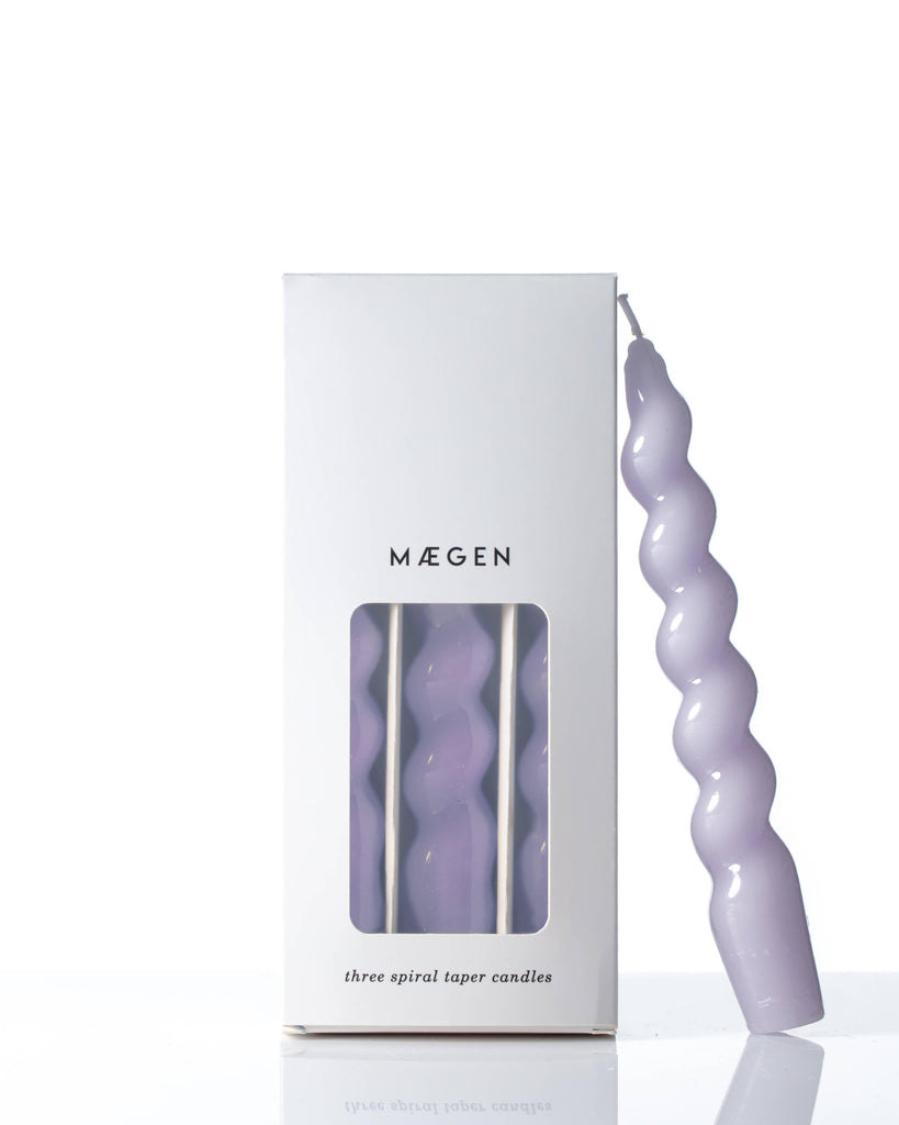Lilac Spiral Taper Candles, elegantly twisted and emitting a warm glow.