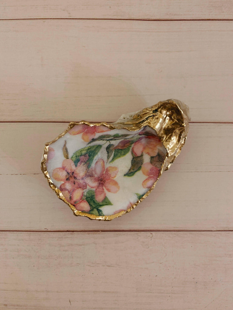 Cherry Blossom Shells, adorned with delicate hand-painted cherry blossom branches, symbolizing life's ephemeral beauty.