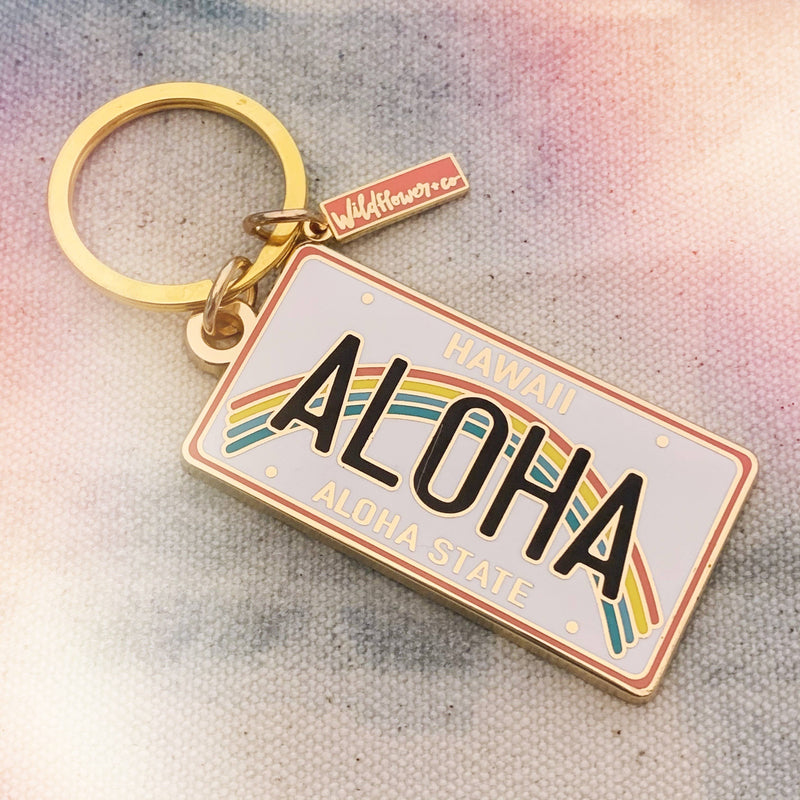 Aloha Enamel Keychain featuring a colorful rainbow and “Aloha” text.