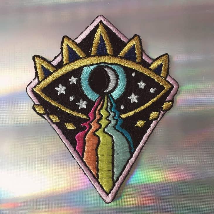 Cosmic Evil Eye Rainbow Patch, featuring a captivating blend of the evil eye symbol, cosmic design, and colorful rainbow.