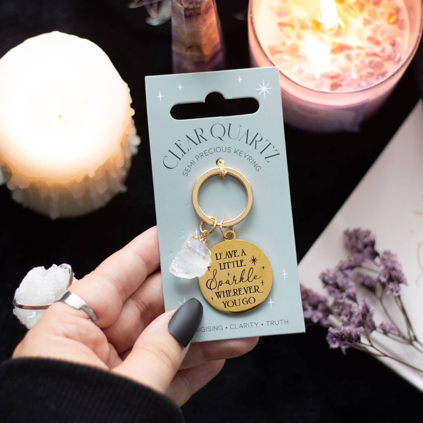 Clear quartz crystal keychain with gold-tone pendant and inspirational message on display card.