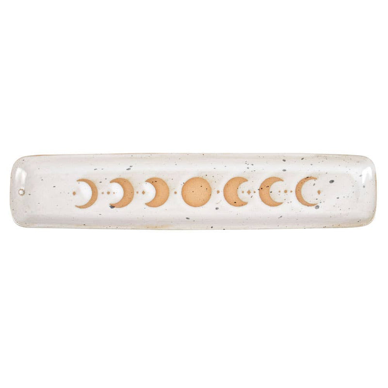 A beautiful stoneware incense holder featuring a moon phase design with a wax resist finish, giving it a handmade feel.