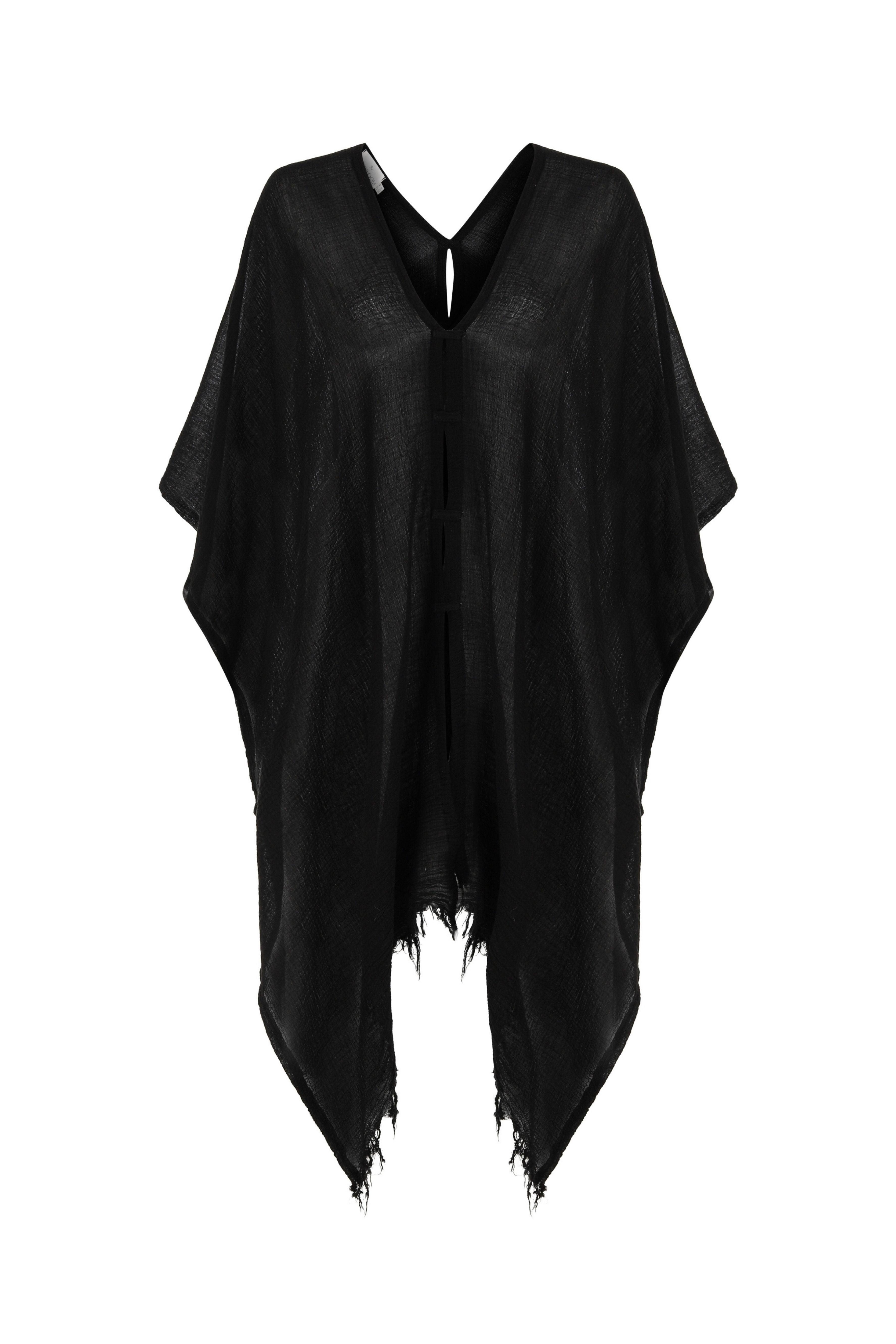 A woman gracefully wearing the Ava Kimono, showcasing its flowing silhouette, delicate patterns, and high-quality fabric.