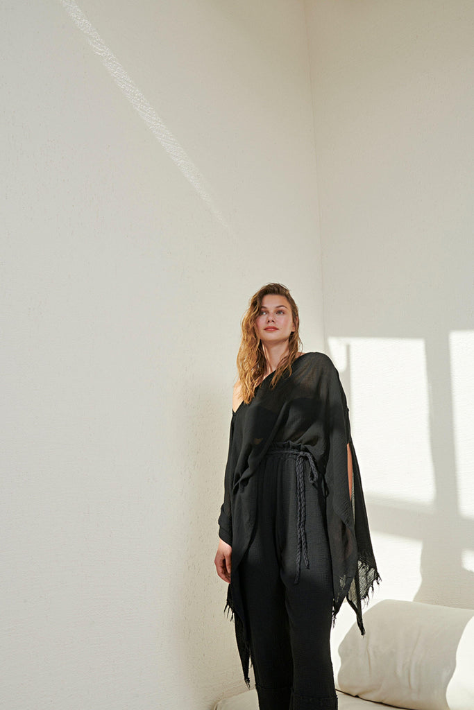 A woman gracefully wearing the Ava Kimono, showcasing its flowing silhouette, delicate patterns, and high-quality fabric.