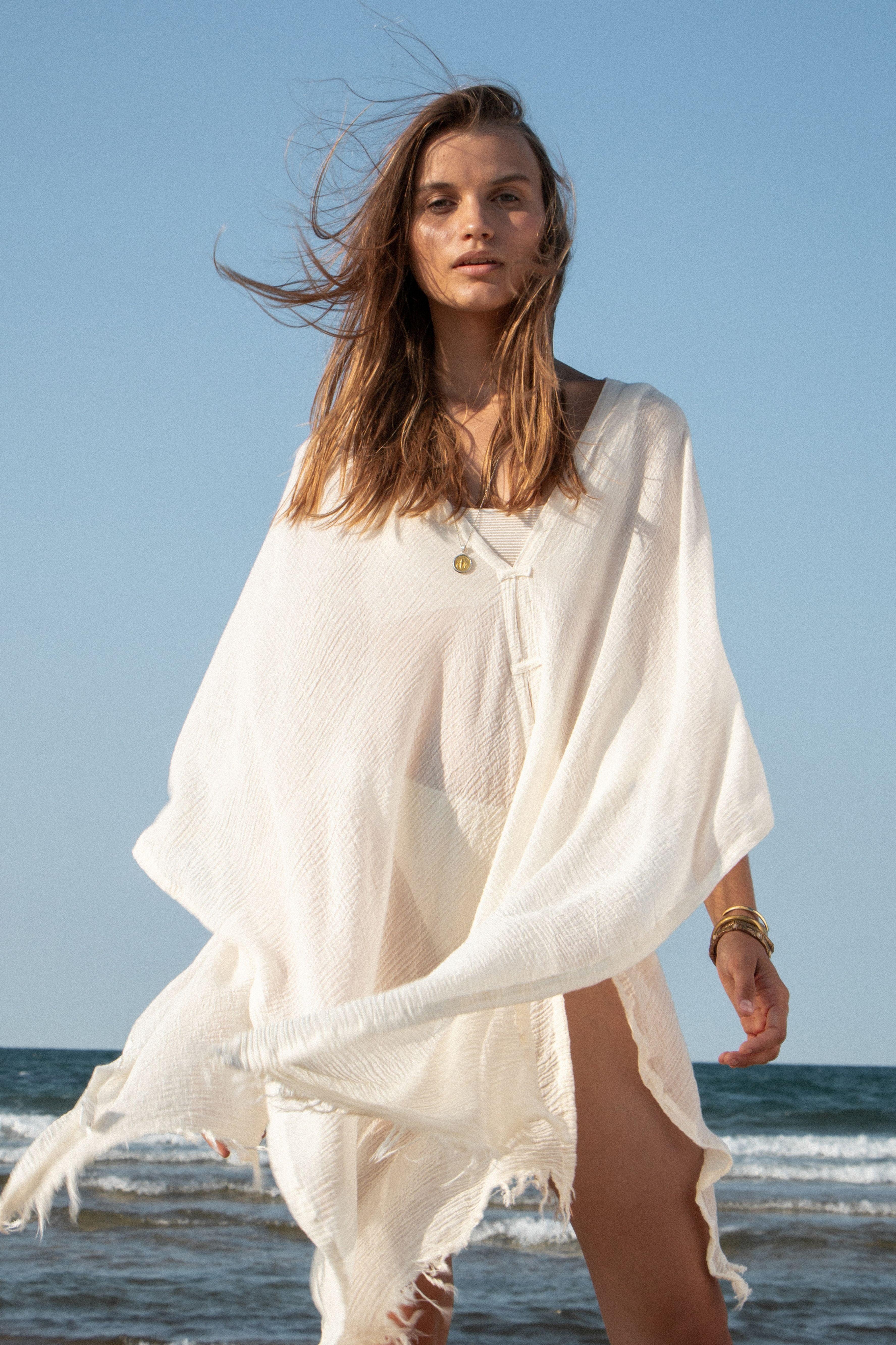 A woman gracefully wearing the Ava Kimono, showcasing its flowing silhouette, delicate patterns, and high-quality fabric.