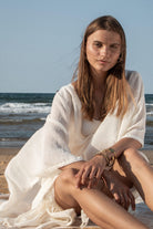 A woman gracefully wearing the Ava Kimono, showcasing its flowing silhouette, delicate patterns, and high-quality fabric.