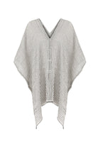 A woman gracefully wearing the Ava Kimono, showcasing its flowing silhouette, delicate patterns, and high-quality fabric.