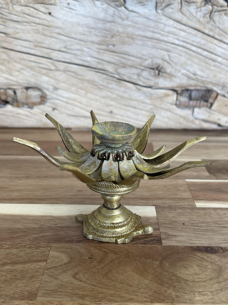A Lotus Incense Holder beautifully designed and placed on a calm background, perfect for securely holding incense sticks and enhancing room decor.