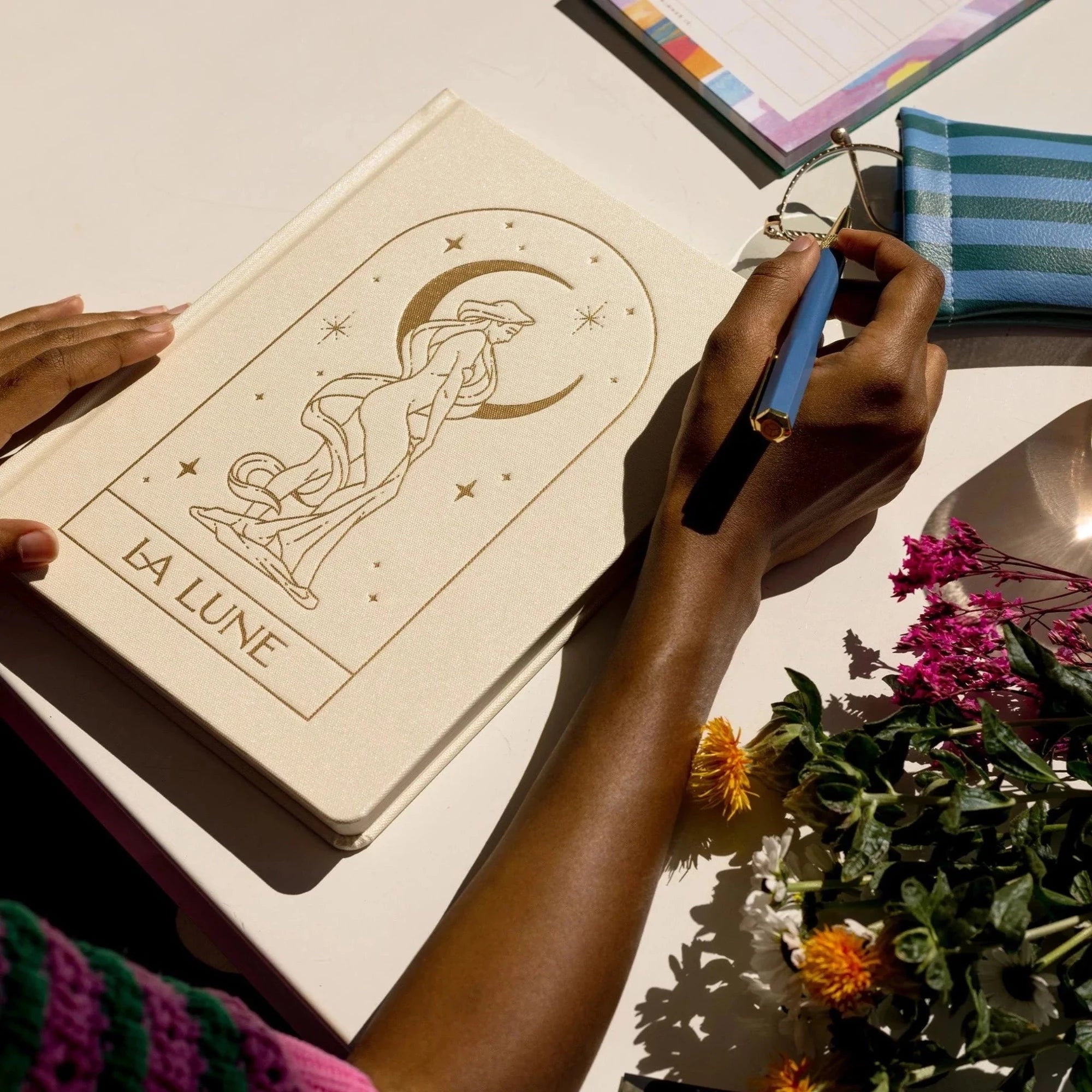Image showcasing the 'La Lune Cloth Covered Journal', adorned with a beautifully designed moon-themed fabric cover.