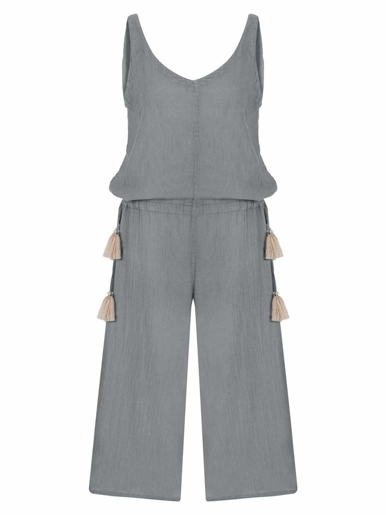 The Venice Jumpsuit, complete with drawstring waist ties with tassels, displayed on a mannequin, highlighting its relaxed fit and stylish design.