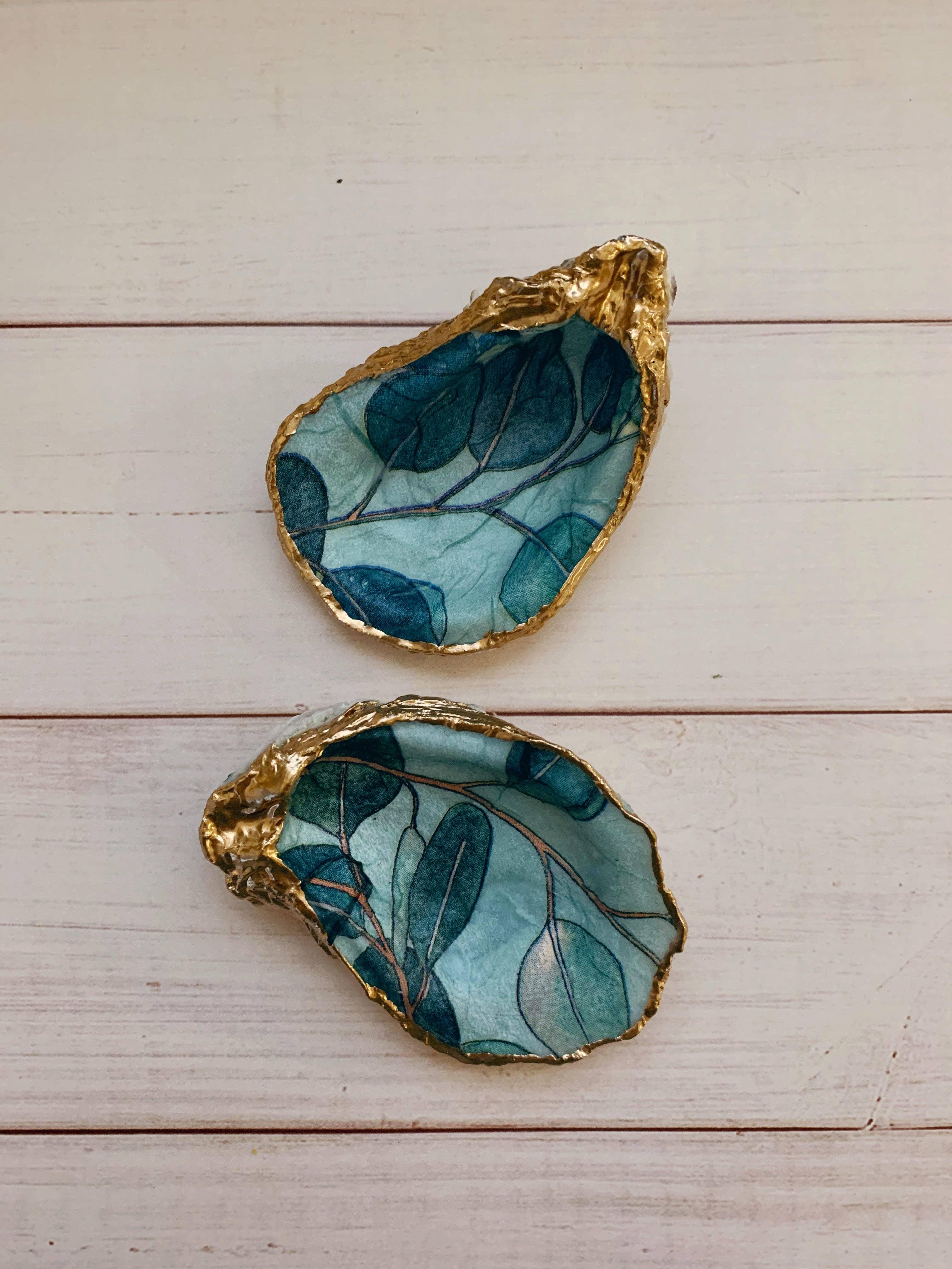 Eucalyptus Shell, painted with soft green eucalyptus leaves, representing calmness and elegance.