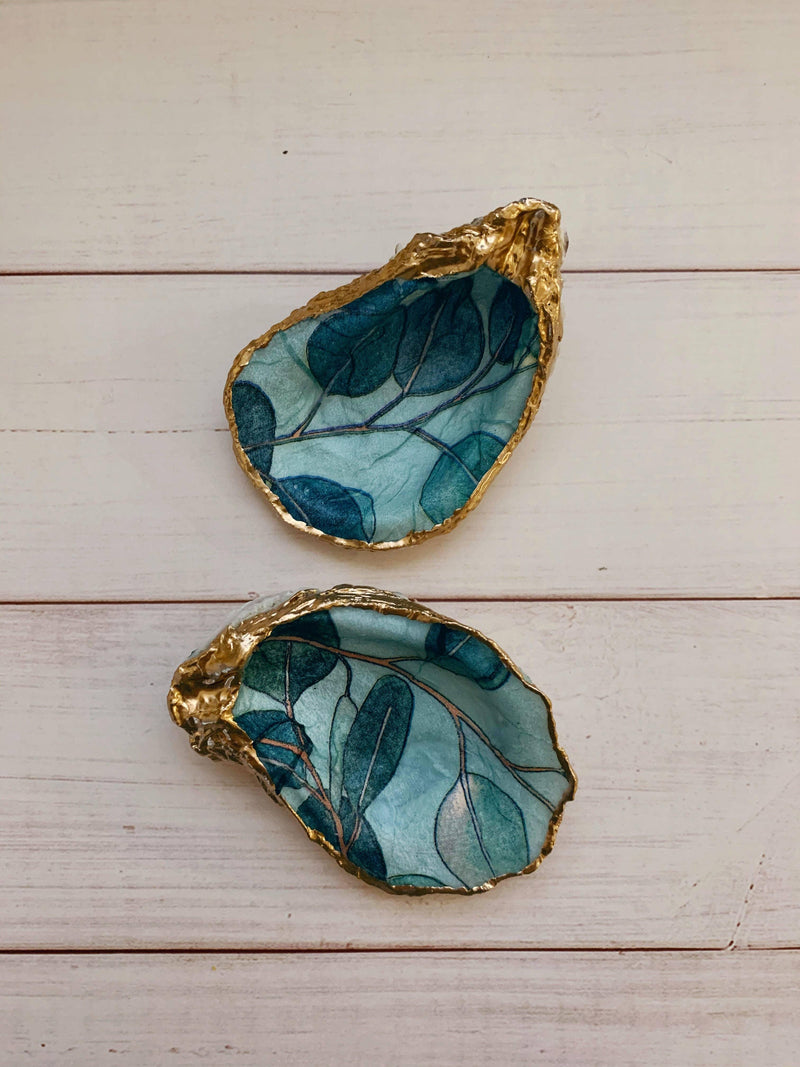 Eucalyptus Shell, painted with soft green eucalyptus leaves, representing calmness and elegance.