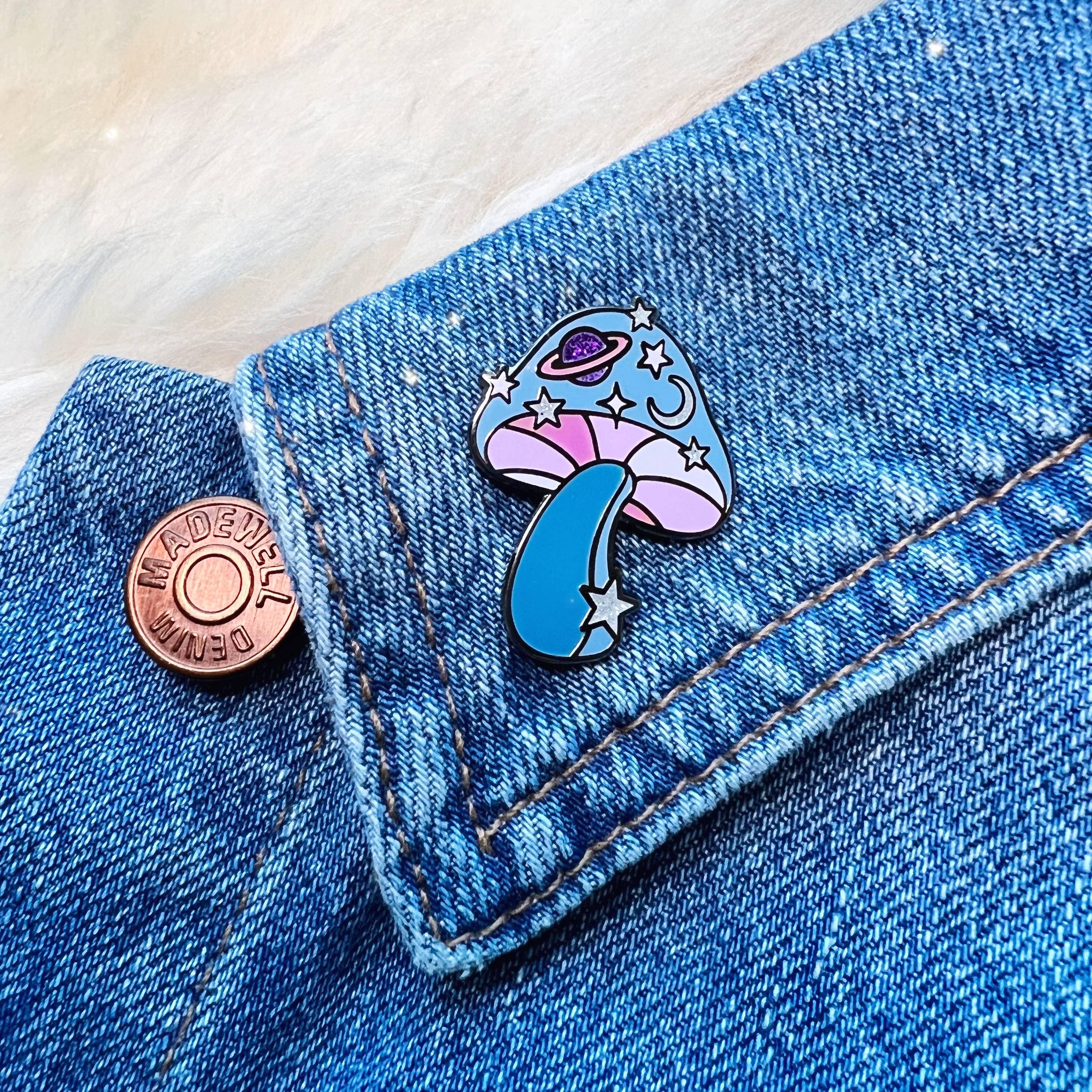 Cosmic Mushroom Enamel Pin, with a creative blend of mushroom and cosmic design, symbolizing the connection between nature and the universe.