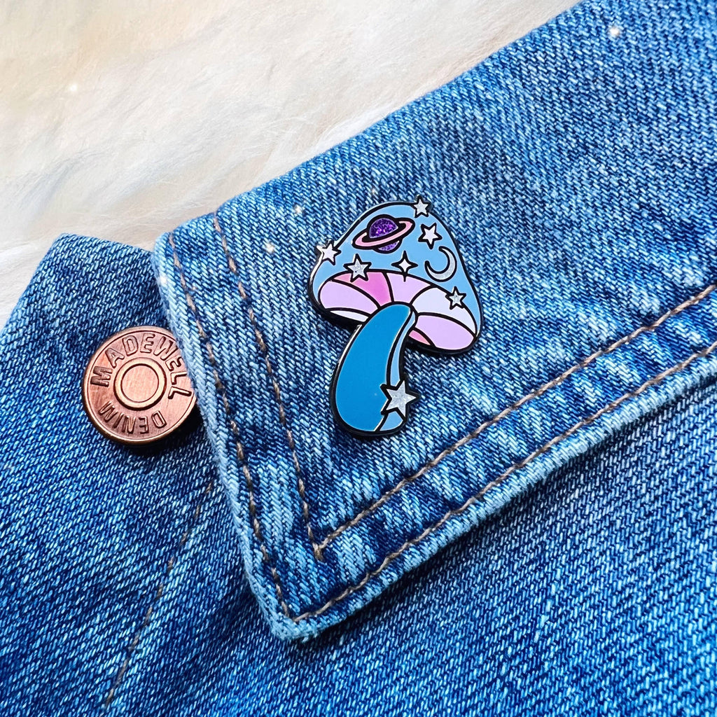 Cosmic Mushroom Enamel Pin, with a creative blend of mushroom and cosmic design, symbolizing the connection between nature and the universe.