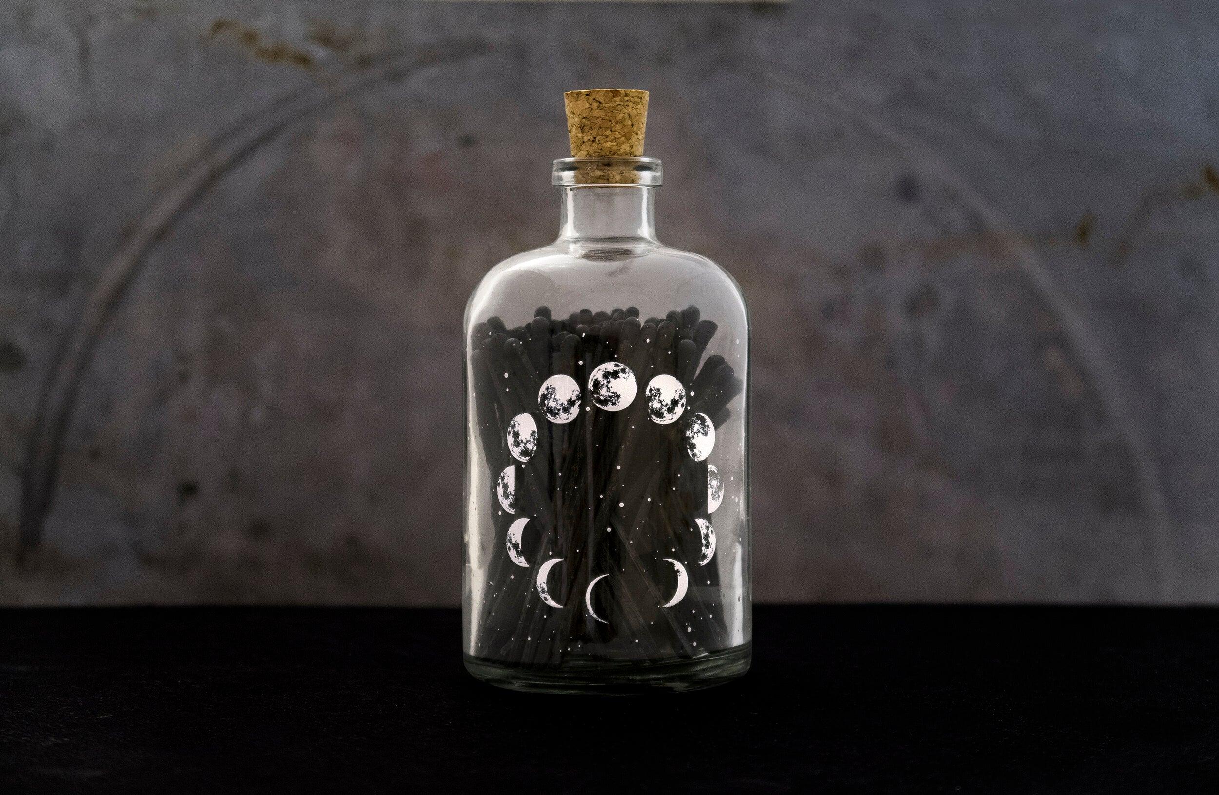 Moon Phase Matches in a stylish matchbox, featuring a celestial design of moon phases, perfect for lighting candles or fires.