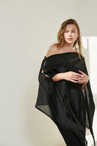 A woman gracefully wearing the Ava Kimono, showcasing its flowing silhouette, delicate patterns, and high-quality fabric.