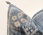 Image showcasing the 'Blue Embroidered Pillow Cover', meticulously crafted from 100% organic cotton and natural fibers, highlighting its intriguing design.