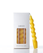 ellow Spiral Taper Candles, beautifully twisted, giving off a warm, bright light.