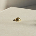 A stylish Brass Arch Incense Holder on a sleek backdrop, exuding modern elegance, designed to hold incense effortlessly.