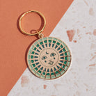 Moon Enamel Keychain featuring a crescent moon design with intricate enamel detailing and a durable metal ring for keys.