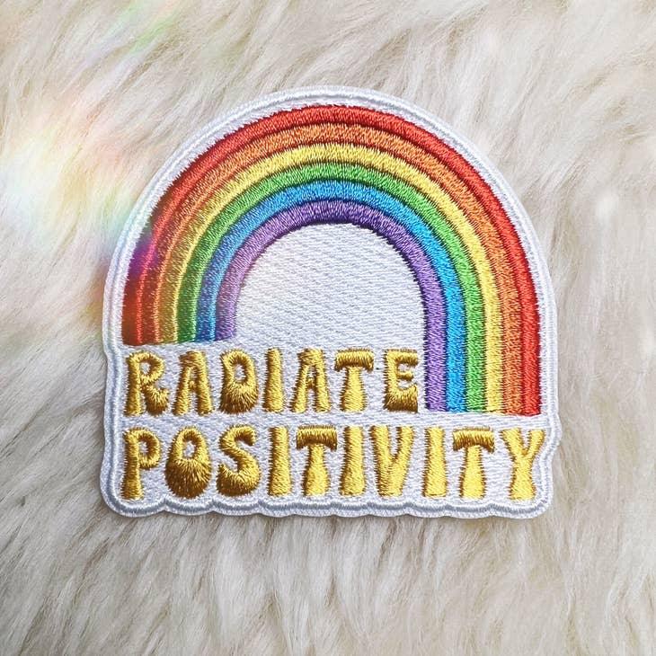 Large vibrant embroidered rainbow patch with "Radiate Positivity" text.