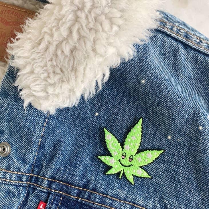 Cosmic Stoner Weed Patch, featuring a weed leaf intertwined with vibrant cosmic designs and celestial symbols.