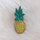 Golden embroidered pineapple patch with detailed green leaves.