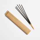 A pack of Sandalwood Rose Incense sticks, gracefully aligned, with rose petals.