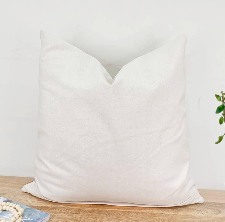 Image of the 'Moroccan Rug Design Embroidered Pillow Cover', highlighting the hand-embroidered motifs, the hand-painted color, and the handmade cotton yarn tassels.