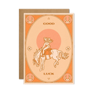  Good Luck Card featuring a lucky charm design on a bright, cheerful background, displayed on a wooden surface.