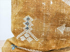 Image of the 'Moroccan Rug Design Embroidered Pillow Cover', highlighting the hand-embroidered motifs, the hand-painted color, and the handmade cotton yarn tassels.