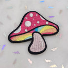 Detailed embroidery patch of a classic woodland mushroom.