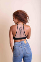 Forma's Moon Tattoo Mesh Bralette, displaying an intriguing moon tattoo design on a sheer backdrop.