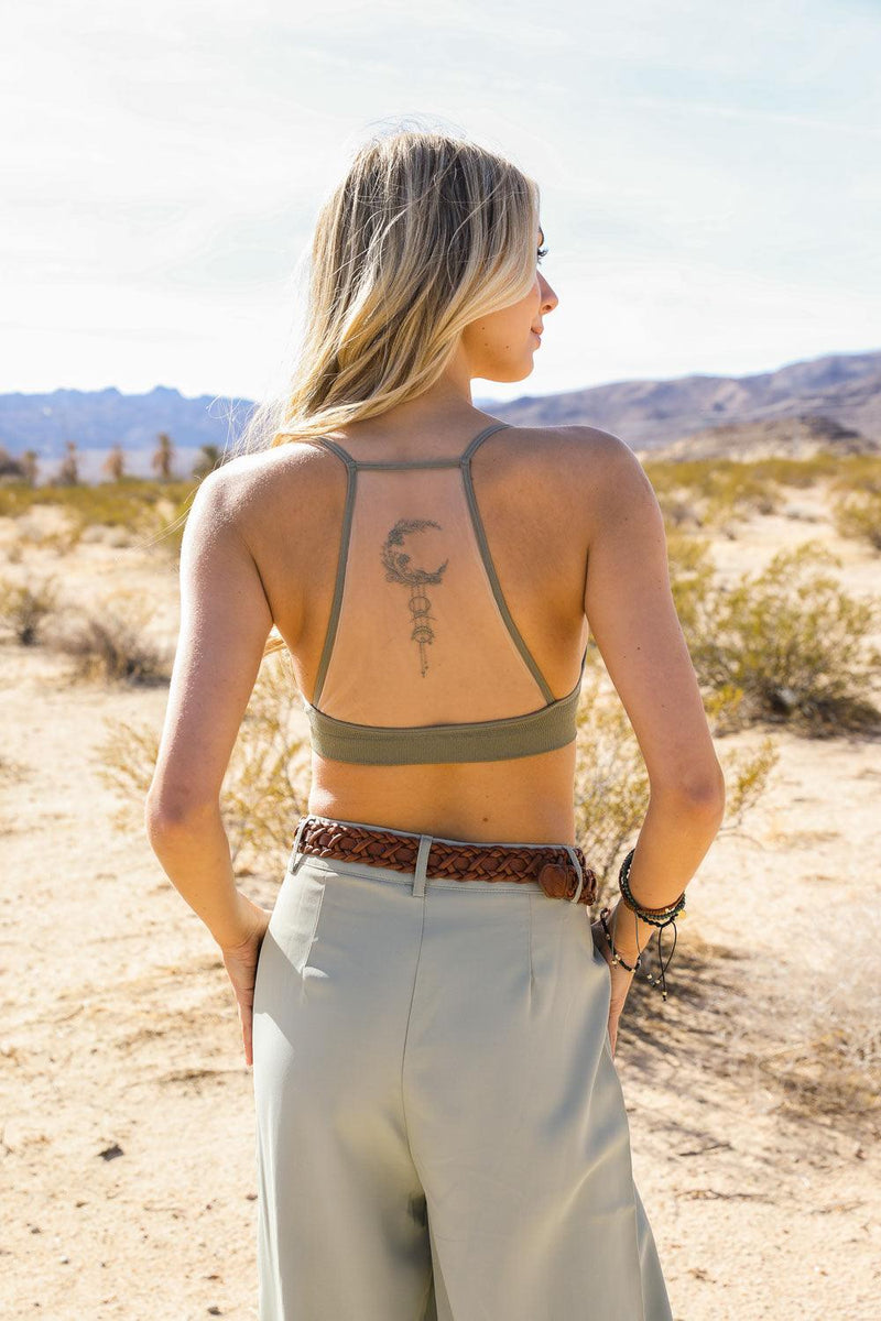 Forma's Moon Tattoo Mesh Bralette, displaying an intriguing moon tattoo design on a sheer backdrop.