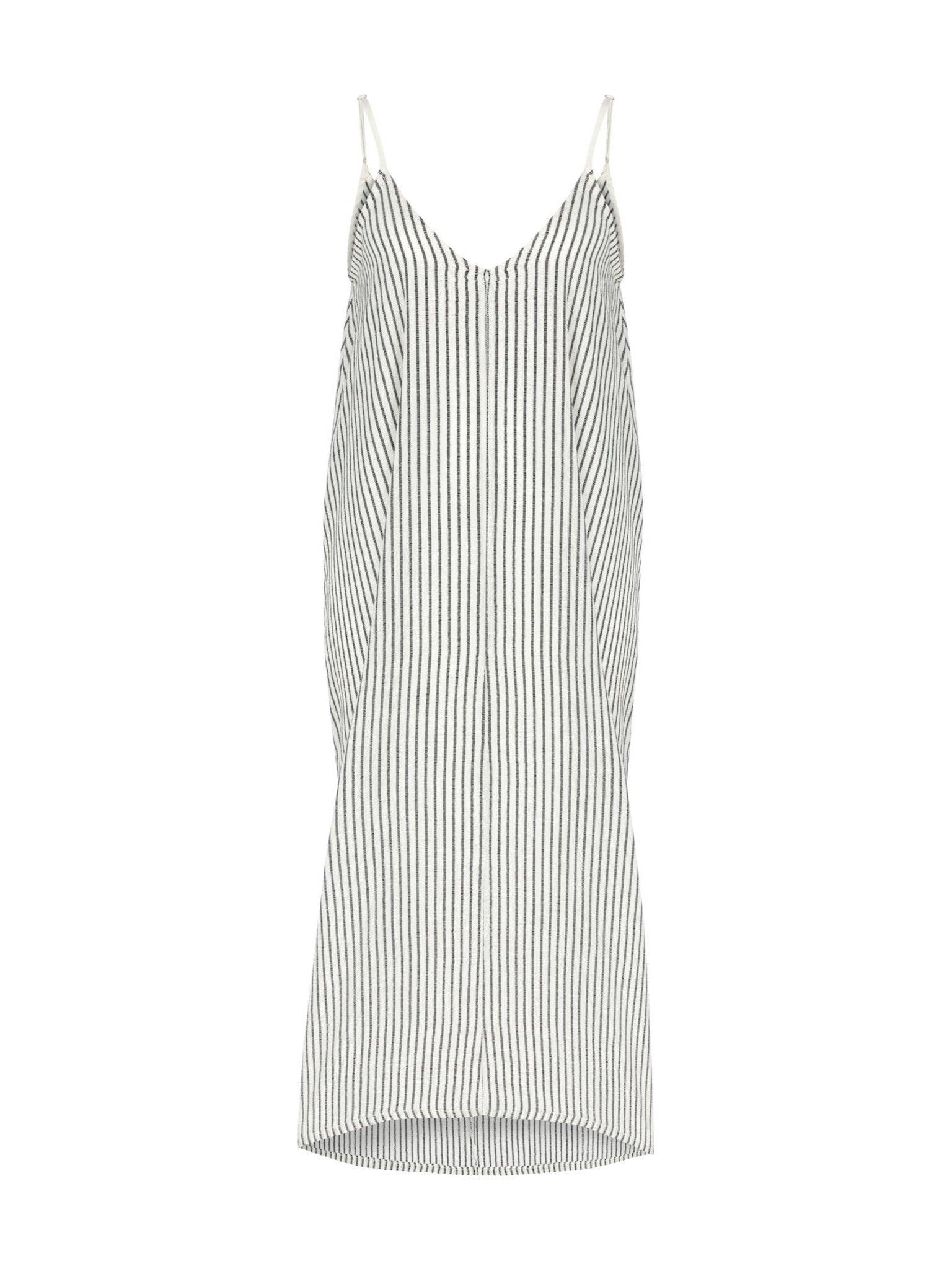 Woman wearing the Yaz Dress, a flowing summer dress with a vibrant print, perfect for sunny days and warm evenings.